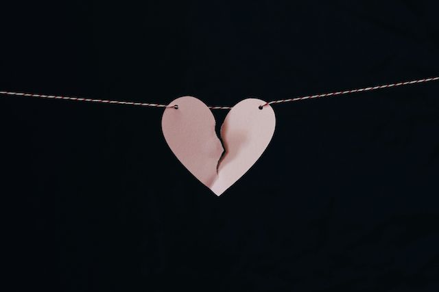 Broken heart on a string: Emotional walls rise slowly, built out of disappointment and self-protection.